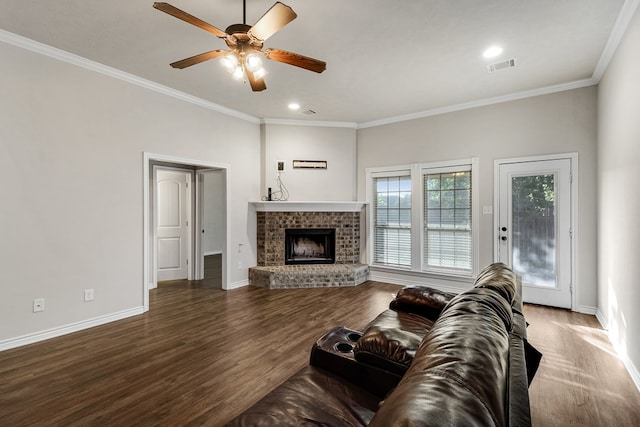 801 Dove Run Trl, College Station, TX 77845 - living area featuring wood finished floors, a brick fireplace, a ceiling fan, ornamental molding, and recessed lighting