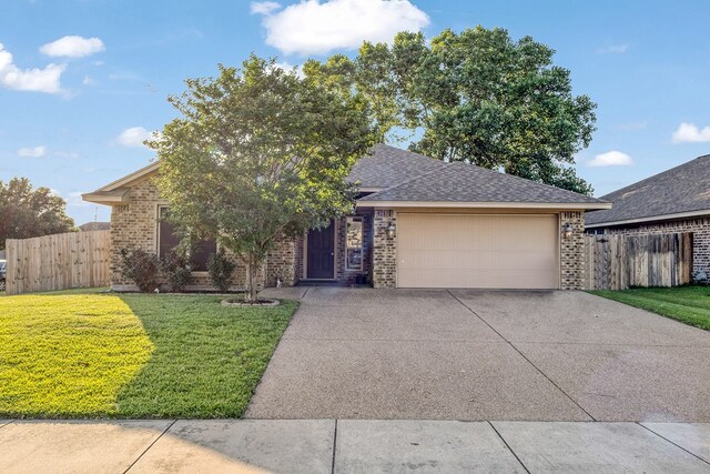 801 Dove Run Trl, College Station, TX 77845 - view of front of home featuring brick siding, driveway, an attached garage, and roof with shingles