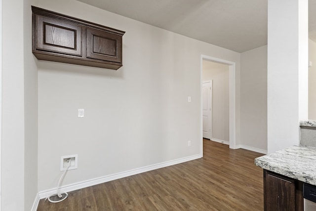801 Dove Run Trl, College Station, TX 77845 - kitchen featuring wood finished floors, dark brown cabinets, and light stone countertops