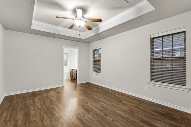 801 Dove Run Trl, College Station, TX 77845 - spare room featuring a raised ceiling, dark wood-type flooring, ornamental molding, and ceiling fan