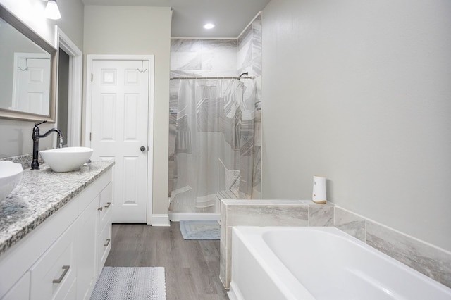 206 Shady Pnes, Lufkin, TX 75901 - full bathroom featuring a shower stall, a bath, wood finished floors, double vanity, and recessed lighting