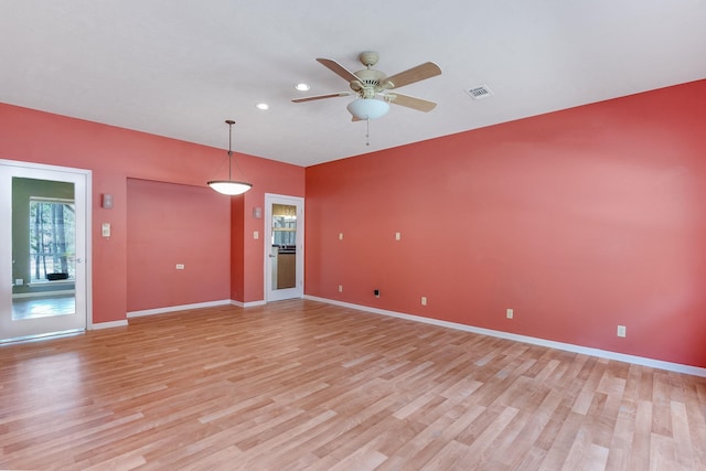 empty room featuring ceiling fan and light hardwood / wood-style flooring