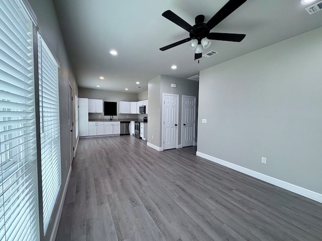 unfurnished living room with ceiling fan and light wood-type flooring