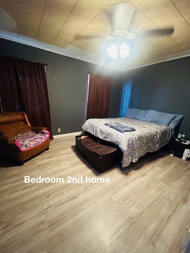 bedroom featuring hardwood / wood-style floors and ceiling fan