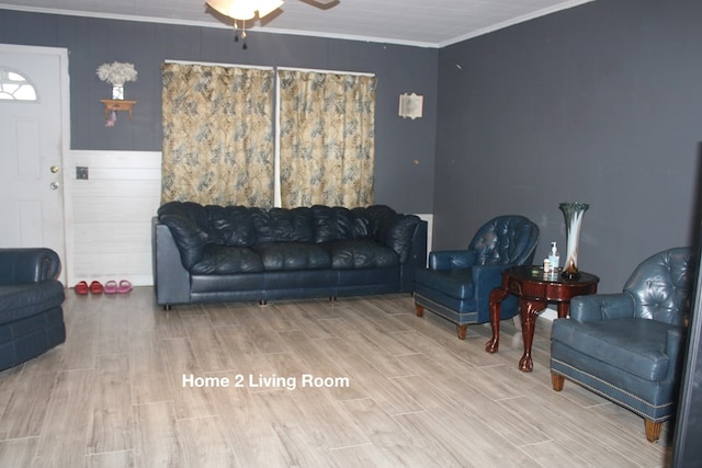 living room with ornamental molding and ceiling fan