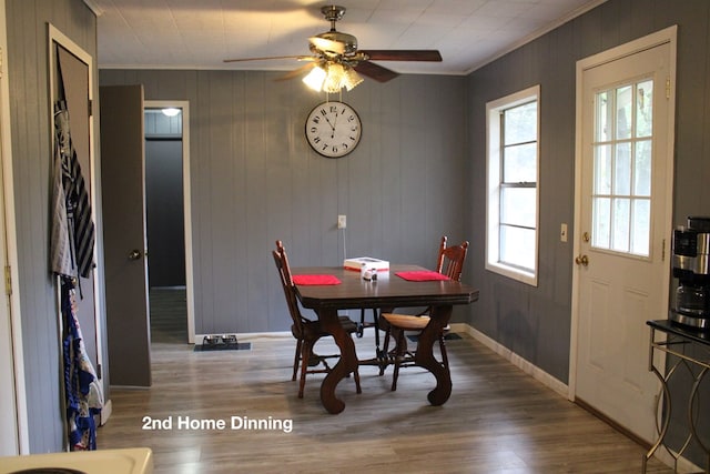 dining space with hardwood / wood-style floors, crown molding, a wealth of natural light, and ceiling fan