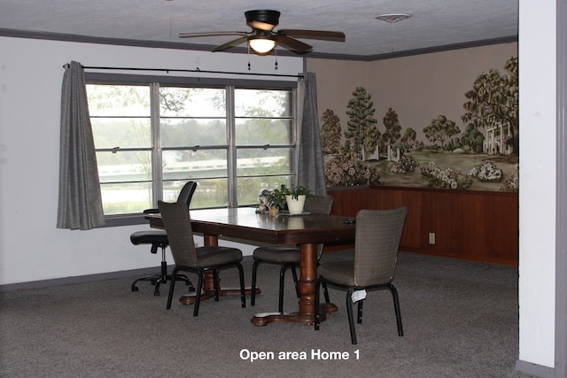 carpeted dining area with ceiling fan, crown molding, and a textured ceiling