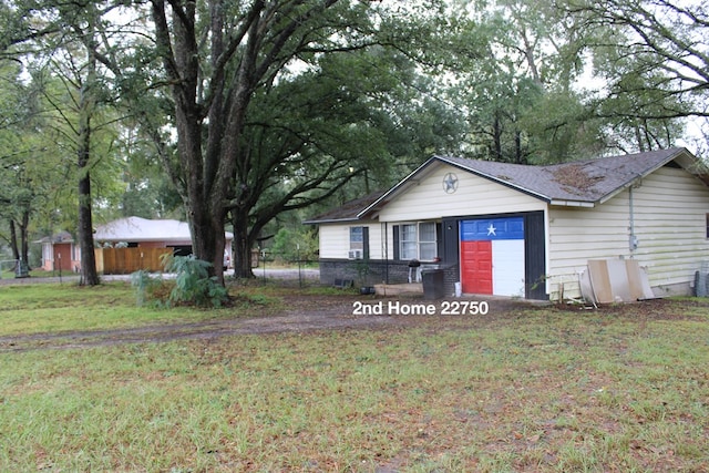 single story home with a garage and a front yard