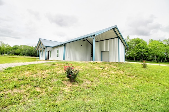 view of pole building featuring a yard and driveway