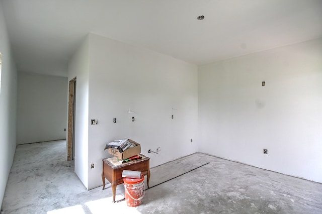 unfurnished room with concrete floors