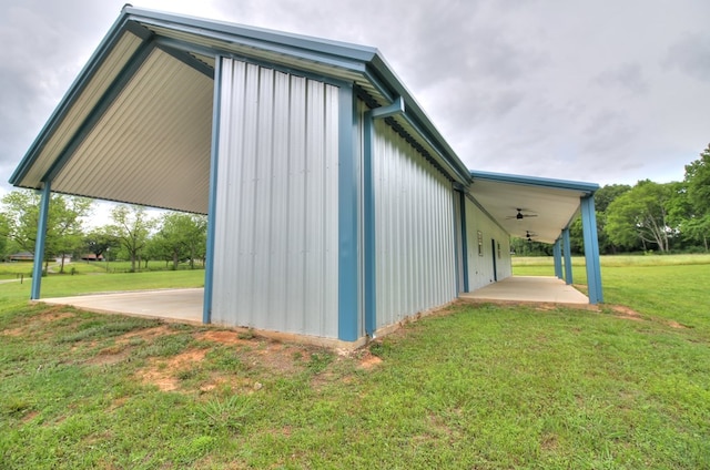 view of side of home with a yard, ceiling fan, and a patio area