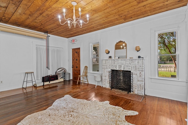 living room with dark hardwood / wood-style floors, wood ceiling, a fireplace, and an inviting chandelier