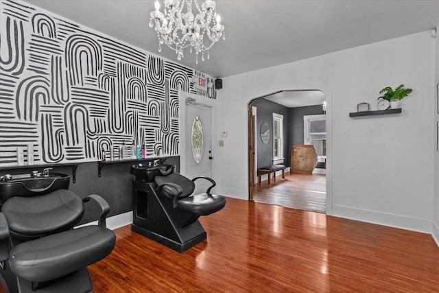 sitting room featuring hardwood / wood-style flooring and a chandelier