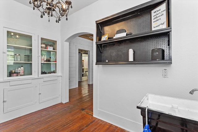 interior space featuring dark hardwood / wood-style flooring and a notable chandelier