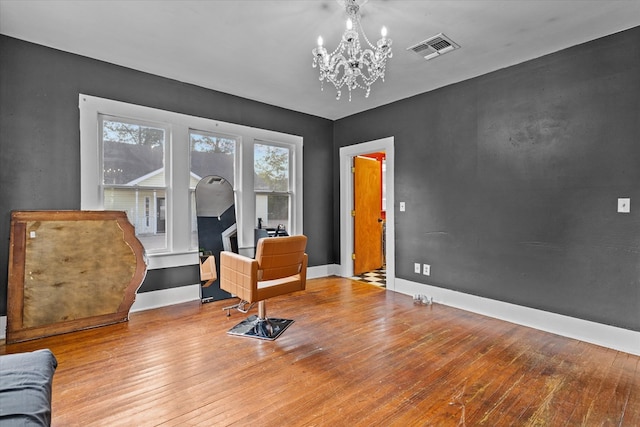 living area featuring light wood-type flooring and a chandelier