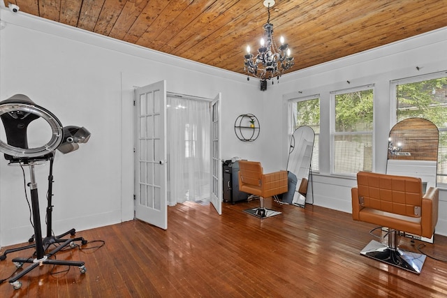 interior space with ornamental molding, an inviting chandelier, wooden ceiling, and hardwood / wood-style flooring