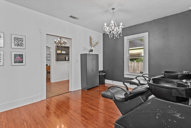 interior space with wood-type flooring and an inviting chandelier