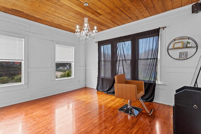 sitting room featuring wooden ceiling, an inviting chandelier, a healthy amount of sunlight, and wood-type flooring