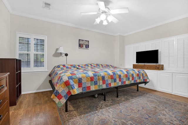 bedroom featuring hardwood / wood-style flooring, ceiling fan, and ornamental molding