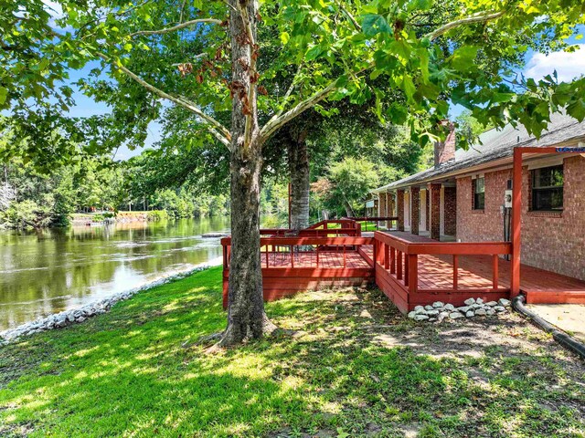 view of yard featuring a deck with water view