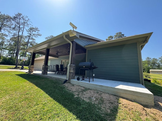 3640 Wingate Blvd, Brookeland, TX 75931 - rear view of property with a lawn, ceiling fan, and a patio