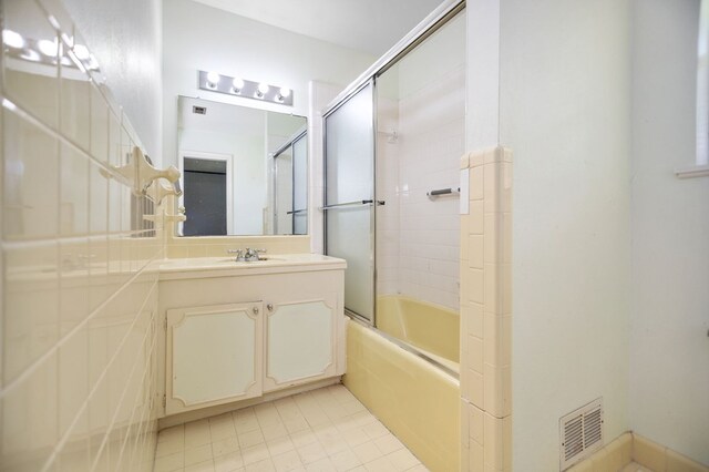 1308 Brook Holw, Lufkin, TX 75904 - bathroom featuring vanity, enclosed tub / shower combo, and tile patterned flooring