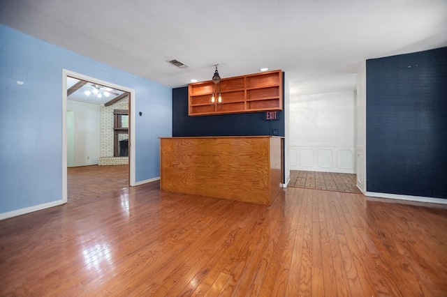 1308 Brook Holw, Lufkin, TX 75904 - unfurnished living room featuring hardwood / wood-style floors, a fireplace, and a ceiling fan