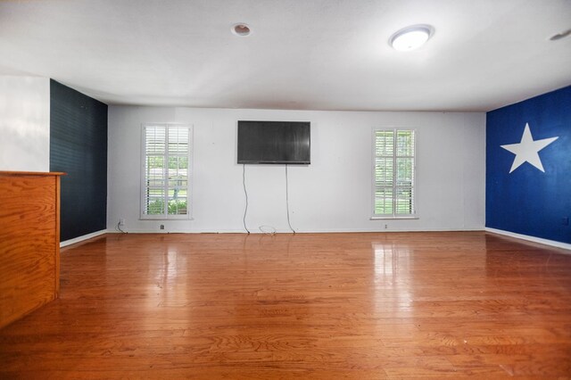 1308 Brook Holw, Lufkin, TX 75904 - unfurnished living room featuring wood finished floors and baseboards