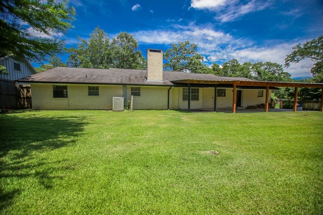 1308 Brook Holw, Lufkin, TX 75904 - back of house featuring a chimney, a yard, brick siding, and a patio area