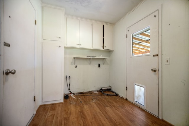 1308 Brook Holw, Lufkin, TX 75904 - washroom featuring cabinet space, light wood-type flooring, crown molding, and washer hookup