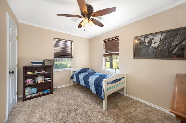 bedroom with baseboards, crown molding, carpet floors, and a ceiling fan