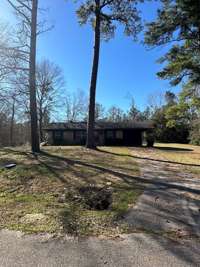 view of front of property with driveway and an attached carport