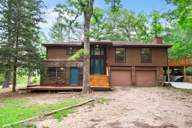 view of front of property featuring a garage and a wooden deck