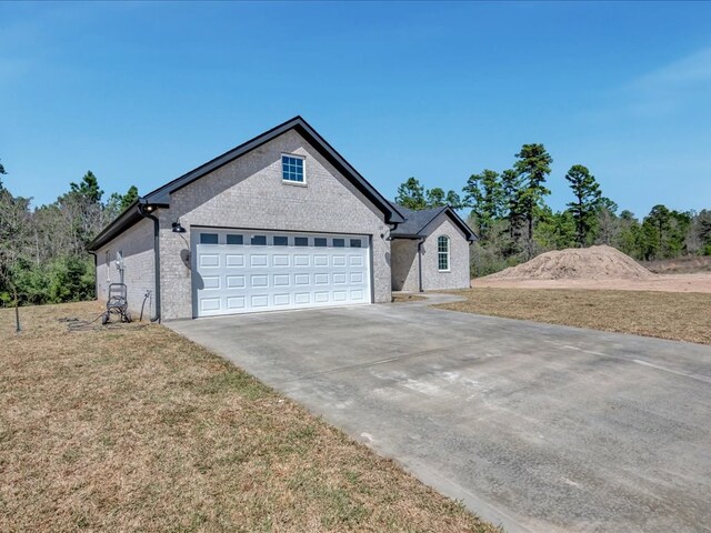 127 Stoney Rdg, Lufkin, TX 75904 - view of front of property featuring concrete driveway, an attached garage, and a front lawn