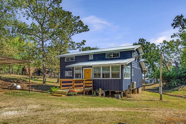 view of front of home with a sunroom and a front lawn