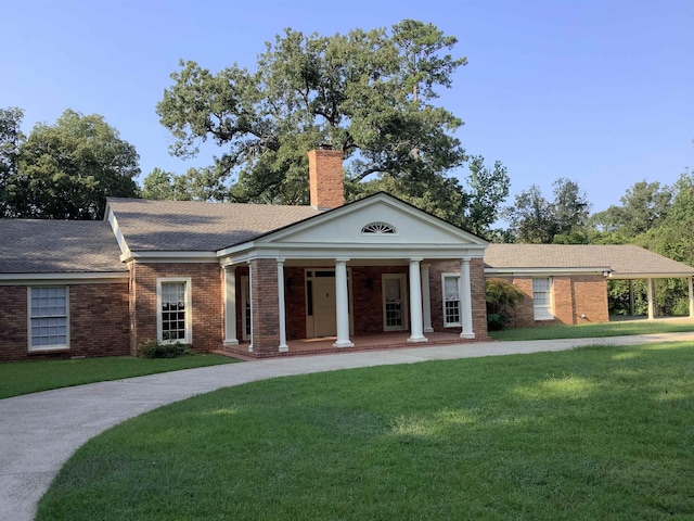 greek revival house featuring a front lawn and a porch