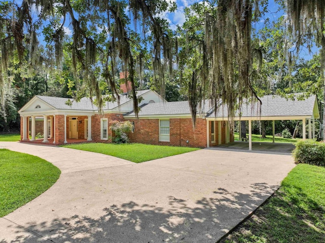 view of front of house with a front lawn and a carport