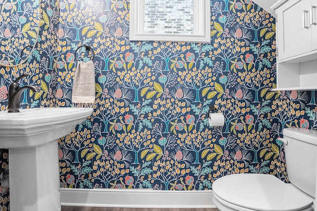 half bath with a sink and toilet