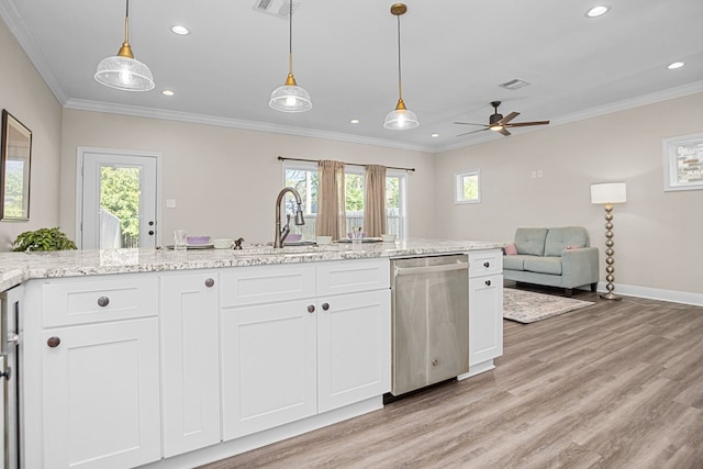 kitchen with pendant lighting, white cabinets, stainless steel dishwasher, and open floor plan