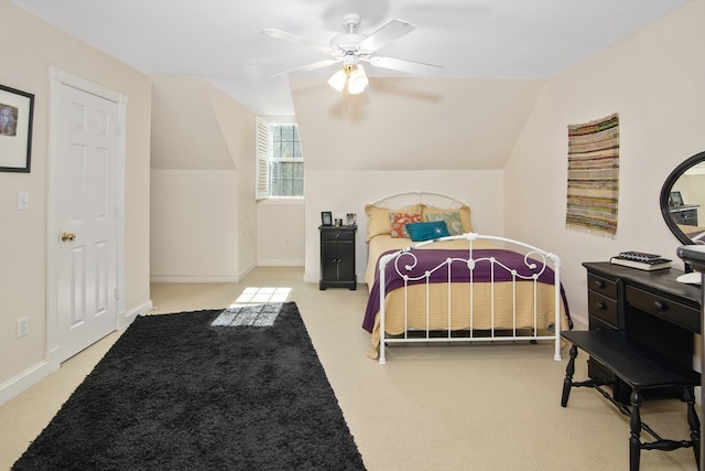 carpeted bedroom with ceiling fan and vaulted ceiling