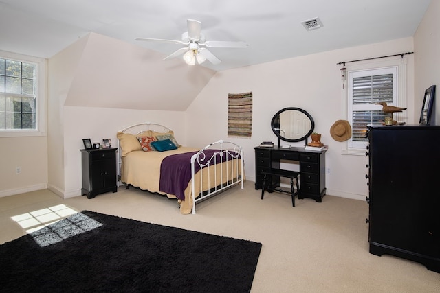 bedroom with visible vents, a ceiling fan, light carpet, vaulted ceiling, and baseboards