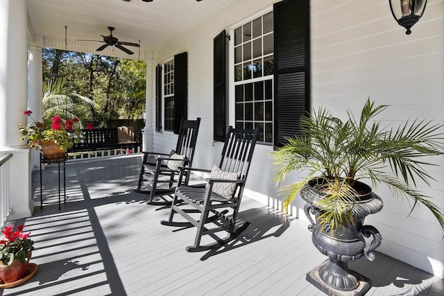 wooden deck with covered porch and a ceiling fan