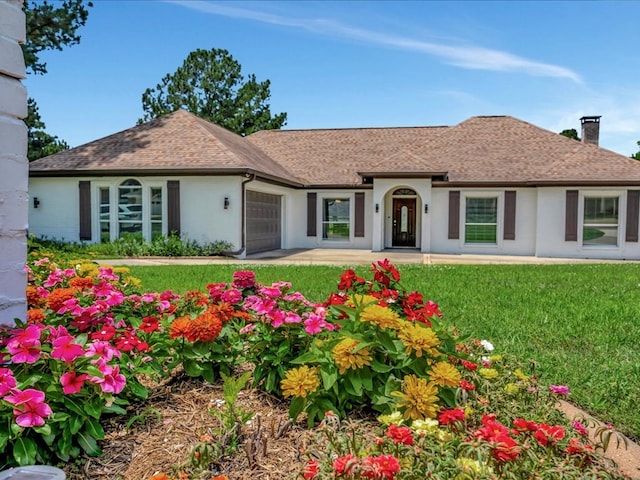 ranch-style house featuring roof with shingles, a chimney, stucco siding, a garage, and a front lawn