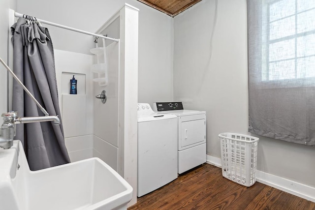 laundry room featuring baseboards, laundry area, dark wood-style flooring, and washer and dryer