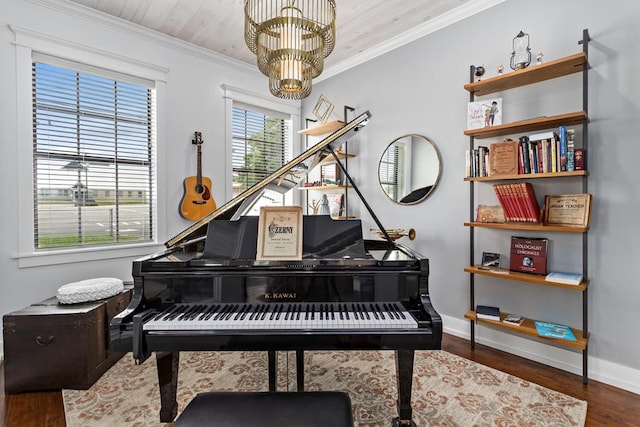 sitting room with crown molding, baseboards, a chandelier, and wood finished floors