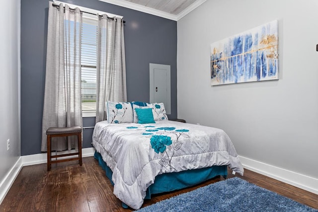 bedroom with crown molding, baseboards, and wood finished floors