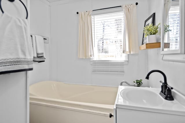 bathroom with vanity and a bath