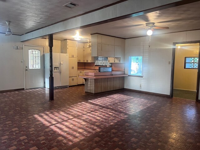 602 Devereaux, Diboll, TX 75941 - kitchen featuring white refrigerator with ice dispenser, ceiling fan, a peninsula, and baseboards