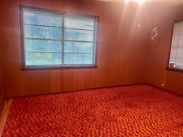 602 Devereaux, Diboll, TX 75941 - carpeted empty room featuring wooden walls and ceiling fan