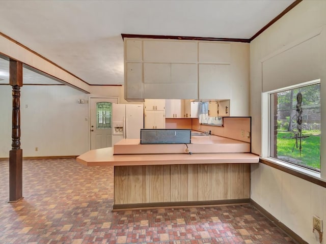 602 Devereaux, Diboll, TX 75941 - kitchen featuring white fridge with ice dispenser, a peninsula, crown molding, and light countertops